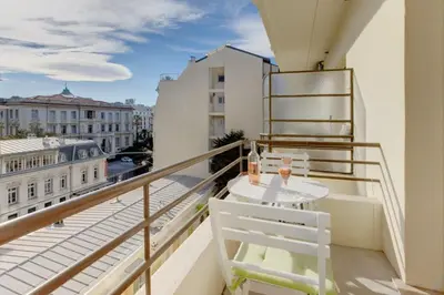a balcony with a table and chairs on a balcony at MyrAzur Carre d'Or in Nice