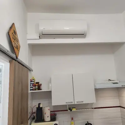 a kitchen with white cabinets and a ceiling at Studio centre ville in Nice