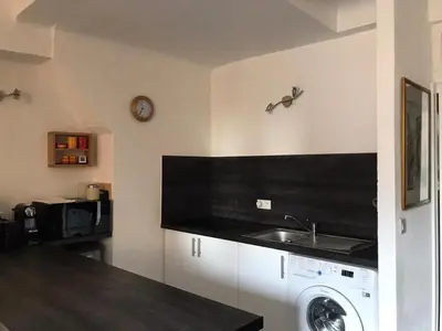 a kitchen with a sink and a washing machine at Rue St Gaetan location old town in Nice