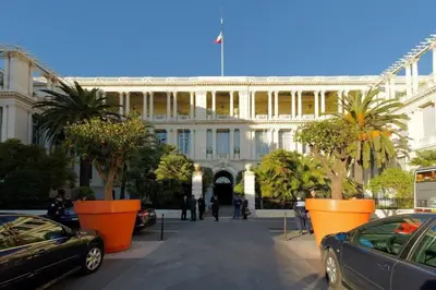 a large building with cars parked in front of it at Rue St Gaetan location old town in Nice