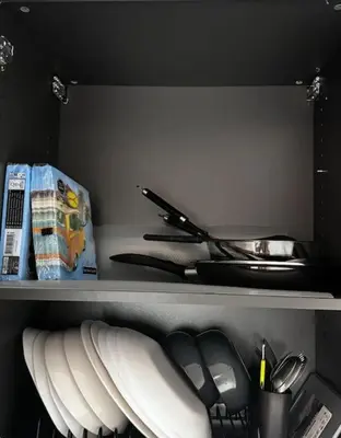 a shelf with plates and utensils in a refrigerator at Studio en bord de mer, Plage 20m, Clim in Cagnes-sur-Mer