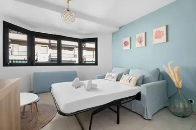 a living room with a couch and a table at Studio Amanda - Welkeys in Nice