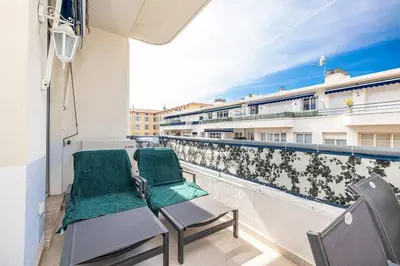 a balcony with two chairs and a railing at Royal Riviera in Nice