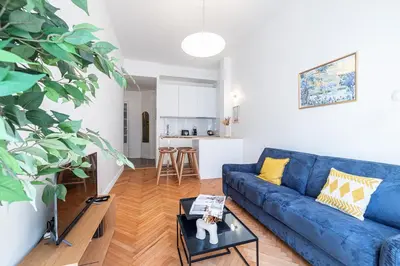 a living room with a blue couch and a table at 10 AMIRAL 201 - Magnifique apt - 2 chambres - Centre-ville in Nice