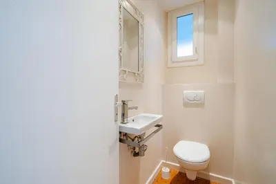 a bathroom with a toilet and a sink at Superbe 3p vue mer avec parking in Nice