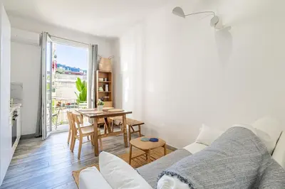 a living room with a couch and a table at Charming Apt Nice Port Place du Pin with Balcony in Nice