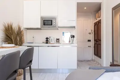 a kitchen with white cabinets and a counter top at 1 GAUTIER 501 - Studio boheme - Quartier du port in Nice