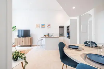a kitchen and living room with a table and chairs at 1 LONGCHAMP - Joli appartement - Carre d Or - Climatise in Nice