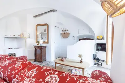 a living room with a red bed and a table at 1 SALEYA LOT 2 - Au coeur du Vieux Nice - 1min de la Plage in Nice