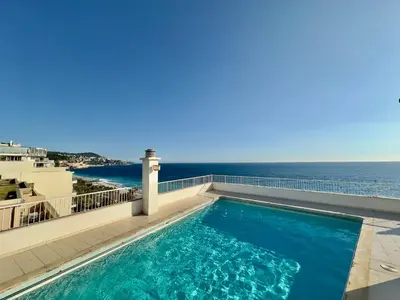 a swimming pool on a balcony overlooking the ocean at L'Éclat Safran - Royal Luxembourg in Nice