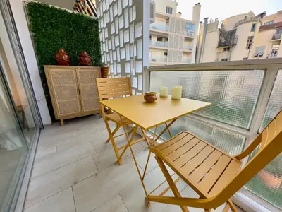 a balcony with a table and chairs on a balcony at L'Éclat Safran - Royal Luxembourg in Nice