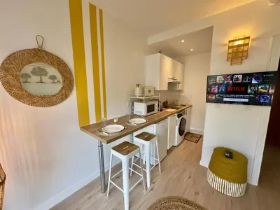 a small kitchen with a counter and a refrigerator at L'Éclat Safran - Royal Luxembourg in Nice