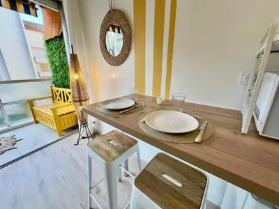 a kitchen with a table with chairs and a mirror at L'Éclat Safran - Royal Luxembourg in Nice