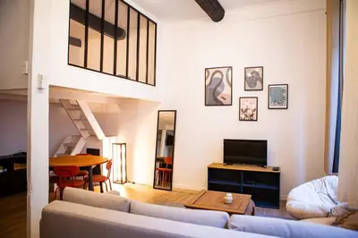 a living room with a couch and a table at Appartement La Mezzanine in Nice