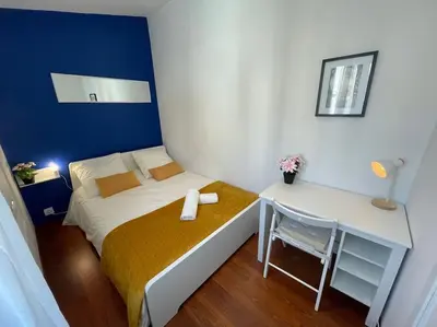 a small bedroom with a bed and a desk at Le Village - cosy flat 5 min walk away from sea in Nice