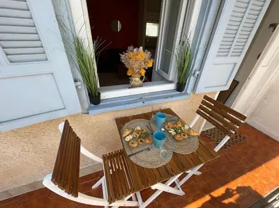 an aerial view of a table and chairs on a porch at Le Village - cosy flat 5 min walk away from sea in Nice