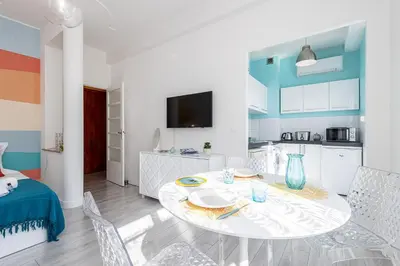 a kitchen and a dining room with a table and chairs at 37 LAMARTINE - Magnifique Studio Art Deco - Centre-ville in Nice