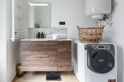 a bathroom with a washing machine and a sink at 37 MASSENA LOT 2 - Superbe 3 pieces - Zone Pietonne - A-C in Nice