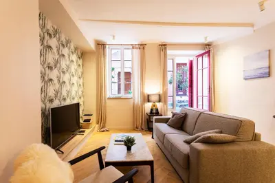 a living room with a couch and a tv at COSY VOLTI AP4434 By Riviera Holiday Homes in Villefranche-sur-Mer