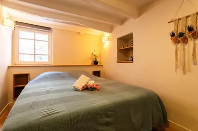 a bedroom with a bed with flowers on it at COSY VOLTI AP4434 By Riviera Holiday Homes in Villefranche-sur-Mer