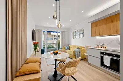 a kitchen and living room with a table and chairs at Massenet Dream,Nice in Nice