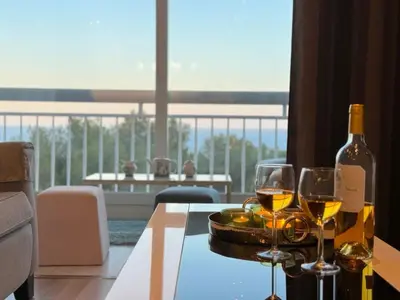 a bottle of wine and two glasses on a table at ⁂ Luxueux 3 pièces 300m de la plage clim sauna in Nice