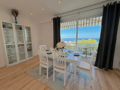 a dining room with a table and chairs and a large window at ⁂ Luxueux 3 pièces 300m de la plage clim sauna in Nice