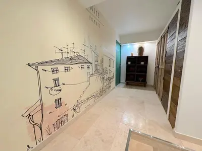 a hallway with a drawing of a house on the wall at ⁂ Magnifique 3P cœur du Vieux Nice in Nice