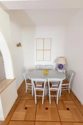 a dining room with a white table and chairs at Magnifique appartement vue mer Mont Borron in Nice