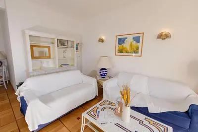 a living room with a white couch and a table at Magnifique appartement vue mer Mont Borron in Nice