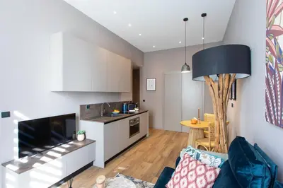 a living room with a couch and a kitchen at #61 1 BDR Rossini Centrale Balcony AC in Nice