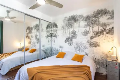 a bedroom with two beds and a mural on the wall at L58 Port Suite 2 BDRS 5mins Old town & Beach Tram in Nice