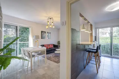 a kitchen and a living room with a table at Dolce vita in Nice