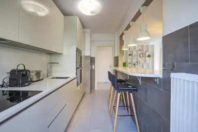 a kitchen with a counter and stools in it at Dolce vita in Nice