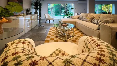 a living room with two couches and a table at Maison LeFleur in Falicon