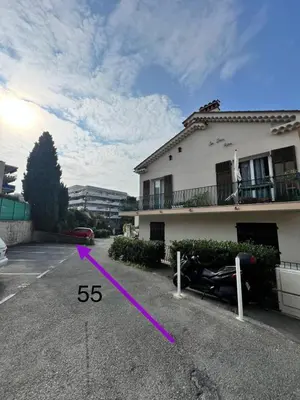 a car parked in a parking lot next to a house at Le Cosy - Spacious - AC - WIFI - Hippodrome - Racetracks - Hypercentre in Cagnes-sur-Mer