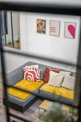 a couch with pillows on it in a room at Spacieux Loft & Central- Vieux Nice in Nice