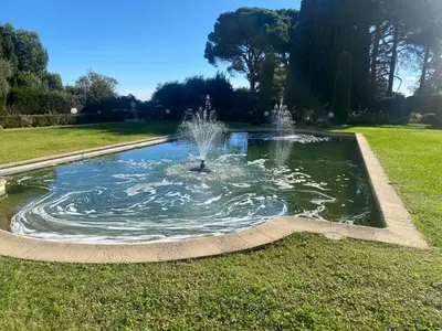 a fountain in the middle of a grassy field at Lovely studio apartment in Nice