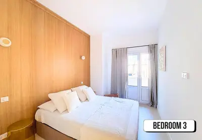a bedroom with a bed with a wooden wall at Nestor&Jeeves - PALMIERS TERRASSE - Central - Terrace in Nice