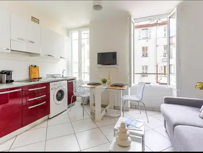a kitchen and living room with a washing machine at Résidence le Paga in Nice