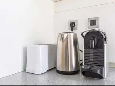 a kitchen counter with a coffee maker and a microwave at Résidence le Paga in Nice