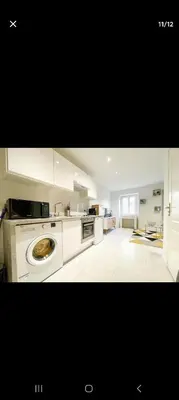 a large kitchen with a washing machine in it at Joli appartement centre de Nice in Nice