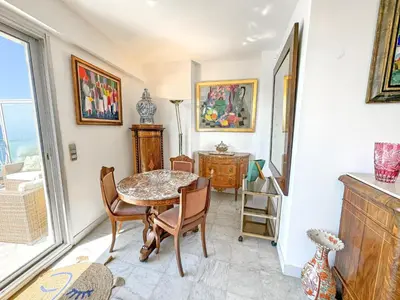 a dining room with a table and chairs at Breathtaking Rooftop Experience on Promenade in Nice