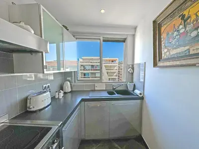 a small kitchen with a sink and a window at Breathtaking Rooftop Experience on Promenade in Nice