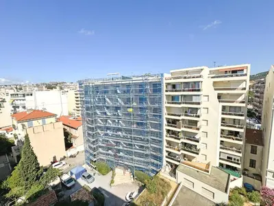 an overhead view of a tall building in a city at Breathtaking Rooftop Experience on Promenade in Nice