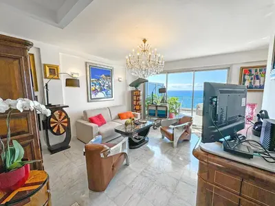 a living room with a couch and a tv at Breathtaking Rooftop Experience on Promenade in Nice