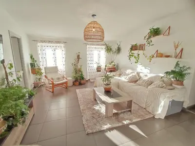 a living room filled with lots of potted plants at Chambre à 3 min de la Promenade des Anglais à pieds 200m in Nice
