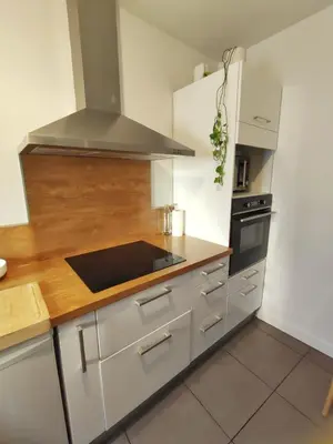 a kitchen with white cabinets and a stove top oven at Chambre à 3 min de la Promenade des Anglais à pieds 200m in Nice
