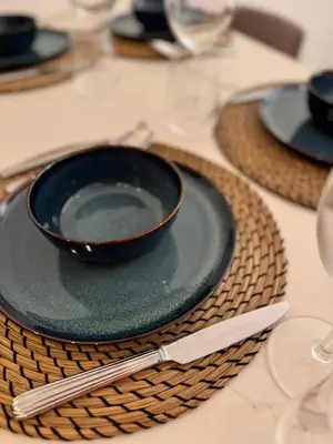 a black plate with a knife on a table at Luxury Central Condo with Private Terrace in Nice in Nice
