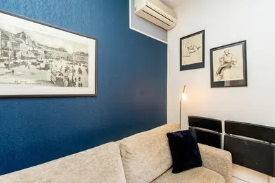 a living room with a couch and pictures on the wall at Palais Magnan 4 Pers WiFi AC in Nice